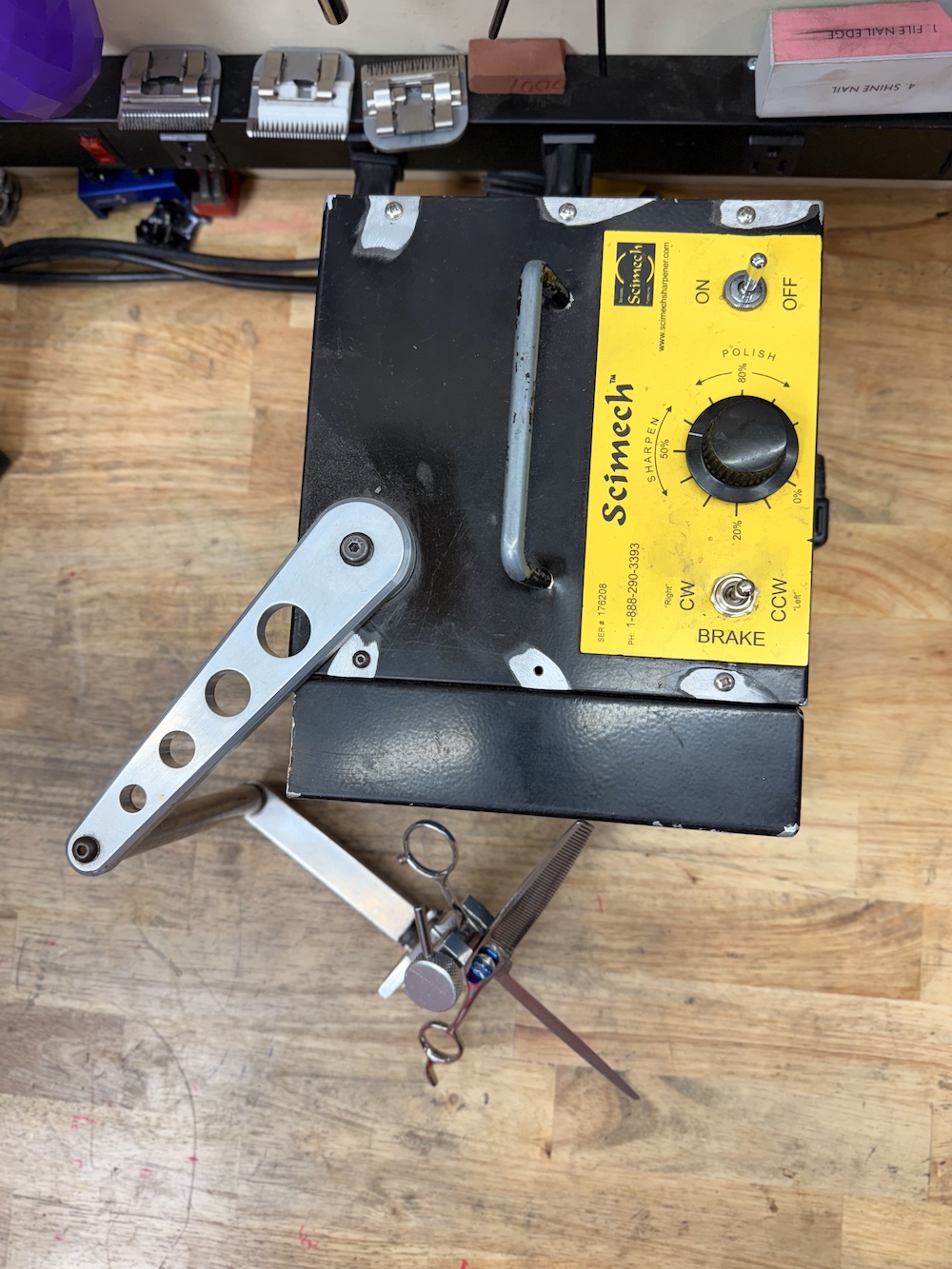 Our Scimech Scissor Sharpening machine on a bench.